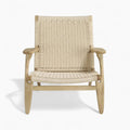 Woven chair with natural wood frame on a white background