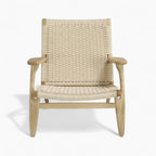 Woven chair with natural wood frame on a white background
